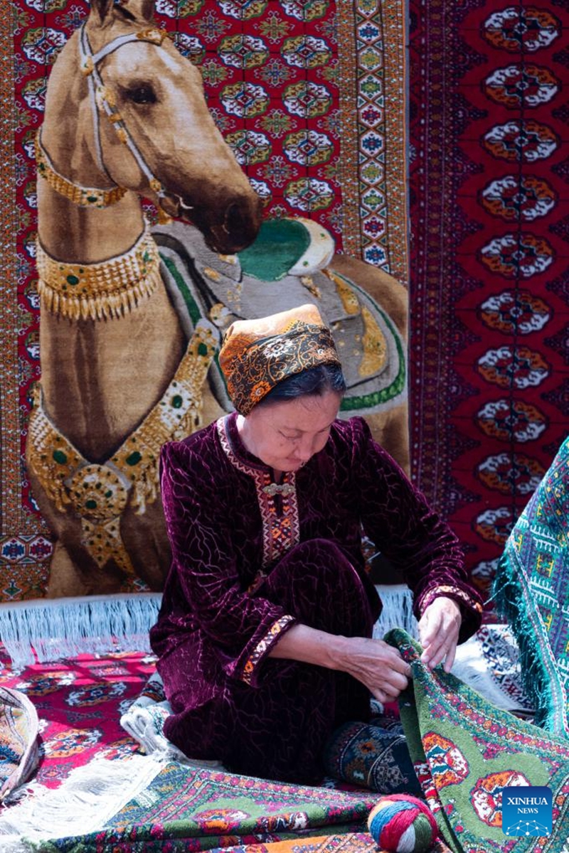 A woman demonstrates carpet-making during a Turkmen Carpet Day celebration in Ashgabat, Turkmenistan, May 31, 2026. (Photo by Cui Jiaxin/Xinhua)