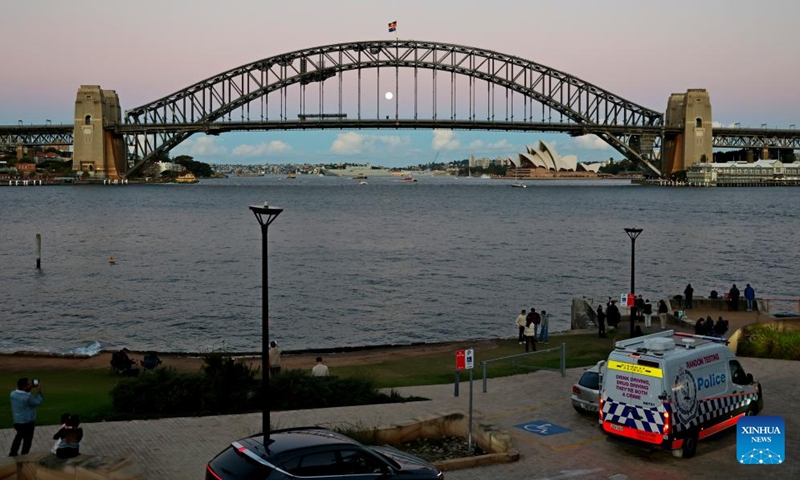The full moon, known as the Blue Moon, is seen behind the Sydney Harbour Bridge in Sydney, Australia, on May 31, 2026. (Xinhua/Gong Bing)