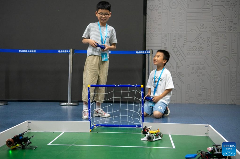 Young players participate in a robot football match at the Yuyao Science and Technology Museum in Yuyao City, east China's Zhejiang Province, May 31, 2026. Various events were held across the country on Sunday to celebrate the upcoming International Children's Day. (Photo by Zhang Hui/Xinhua)