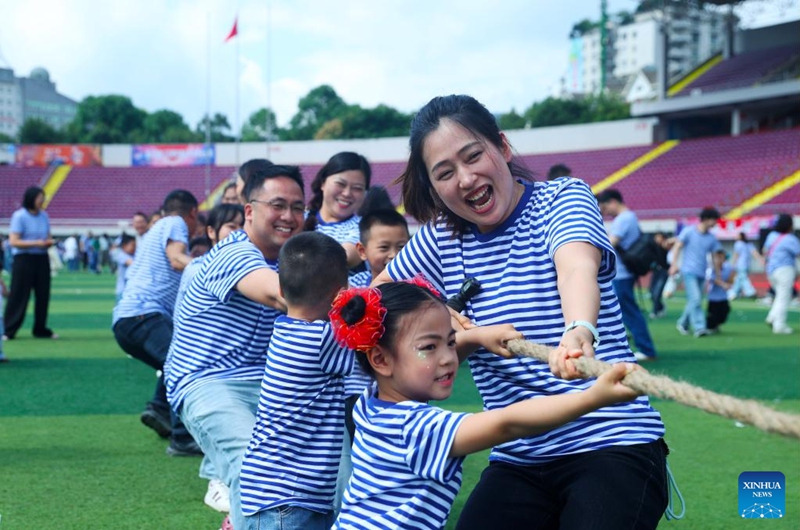 Kindergarten children and their parents participate in a tug-of-war game at a stadium in Qianjiang District, southwest China's Chongqing Municipality, May 31, 2026. Various events were held across the country on Sunday to celebrate the upcoming International Children's Day. (Photo by Yang Min/Xinhua)
