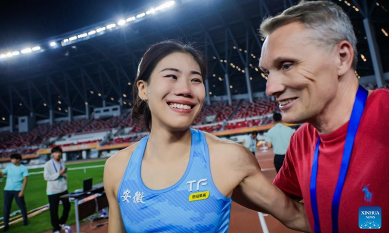 Niu Chunge (L) reacts after setting a new Asian record of 4.73m during the women's pole vault final 2026 National Athletics Grand Prix in Bengbu City, east China's Anhui Province, May 31, 2026. (Photo by Chen Bo/Xinhua)
