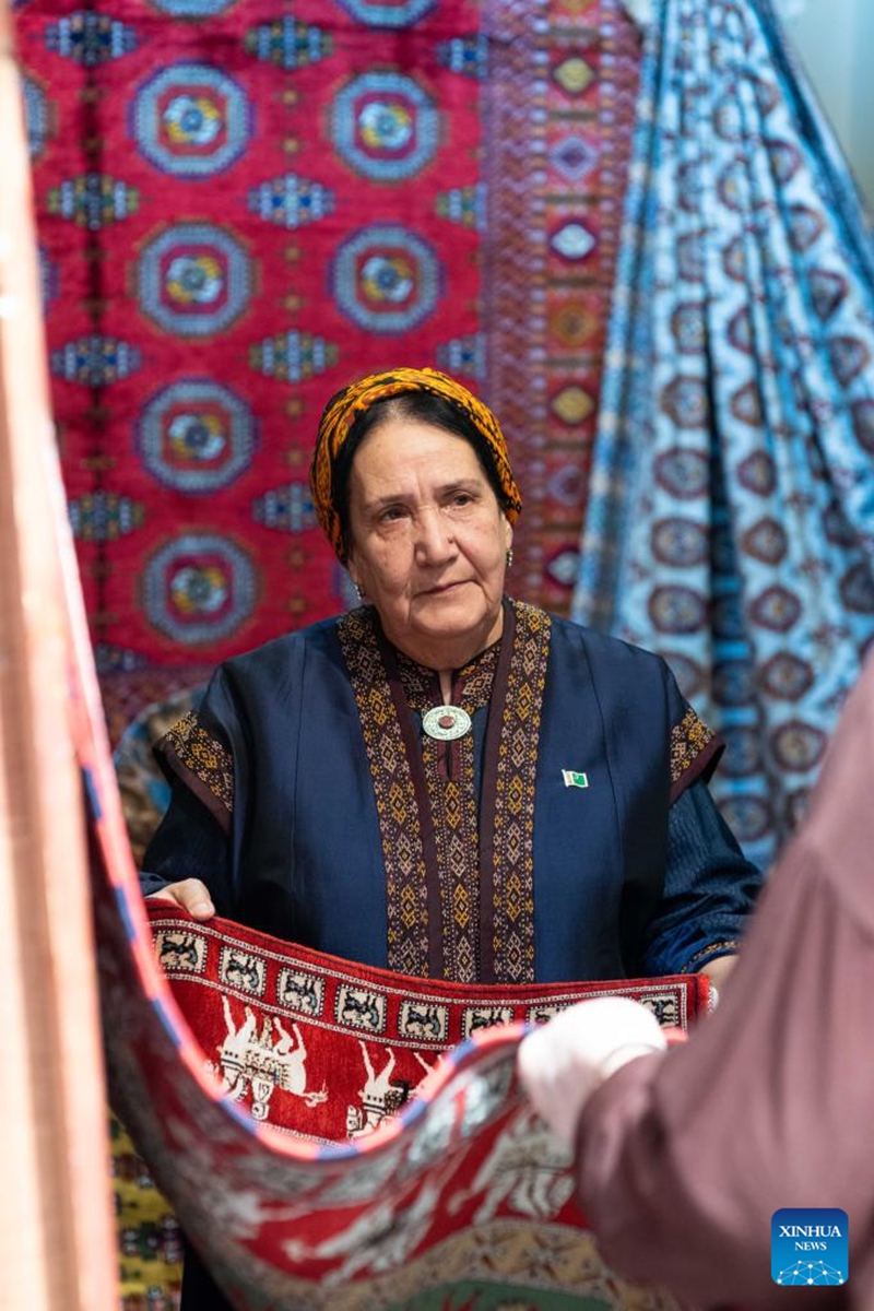 An exhibitor displays a carpet at an exhibition on the Turkmen Carpet Day in Ashgabat, Turkmenistan, May 31, 2026. (Photo by Cui Jiaxin/Xinhua)