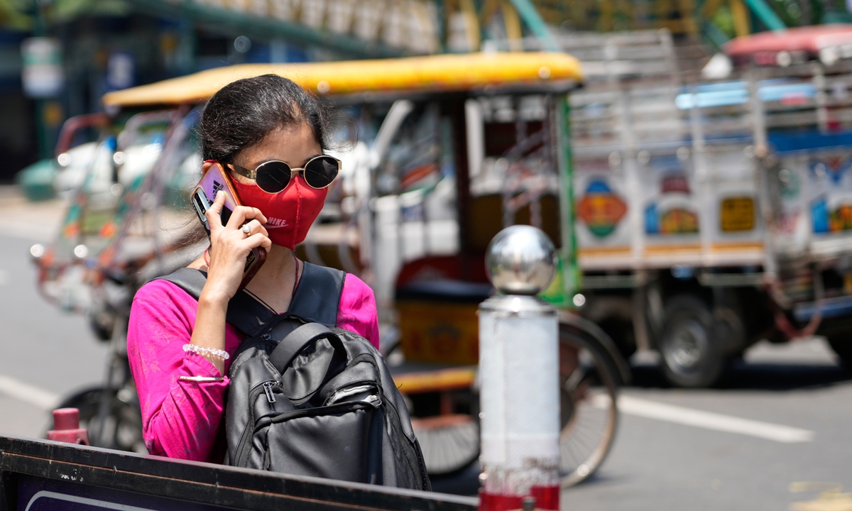 A woman covering her face walks in the sun on a hot summer day in Kolkata, India, Monday, June 1, 2026. Photo: VCG