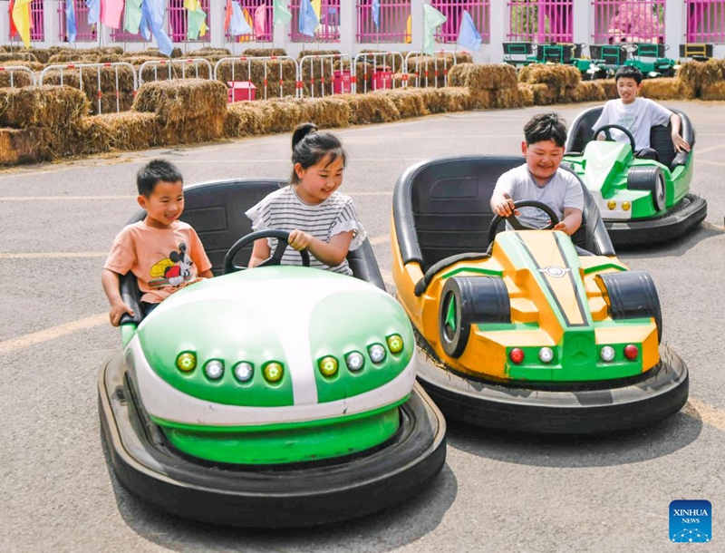 Children play bumper cars at a scenic area of Zunhua City, north China's Hebei Province, May 31, 2026. Various events were held across the country on Sunday to celebrate the upcoming International Children's Day. (Photo by Liu Mancang/Xinhua)