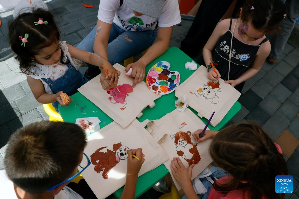 Children color animal drawings during an open door event marking International Children's Day at Romania's Parliament Palace in Bucharest, Romania, June 1, 2026. (Photo: Xinhua)