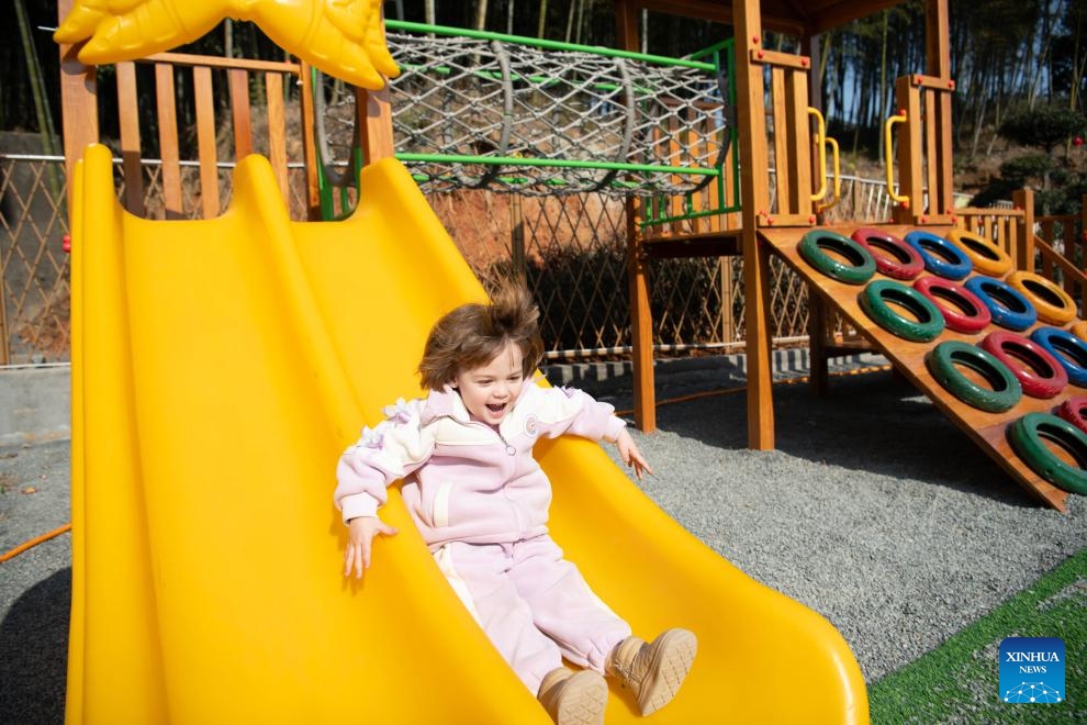 Maya plays at a park in Dongting Town of Guangde City, east China's Anhui Province, Jan. 15, 2026. Four-year-old Maya Ivanou moved to China with her parents in 2023. The family settled in Dongting Town, home to the Yangtze River Delta International Equestrian Center. Maya's mother, Aleksandra Timofeeva, better known as Sasha, is an equestrian from Russia and her father, Vasil Ivanou, a coach from Belarus. (Photo: Xinhua)