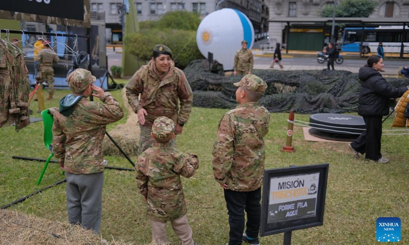 Three boys interact with a soldier during the Argentine Army Equipment Exhibition at the Plaza de Armas near the Ministry of Defense in Buenos Aires, Argentina, June 1, 2026. Argentine Army Equipment Exhibition is held at the Plaza de Armas near the Ministry of Defense from May 30 to June 2. (Photo: Xinhua)