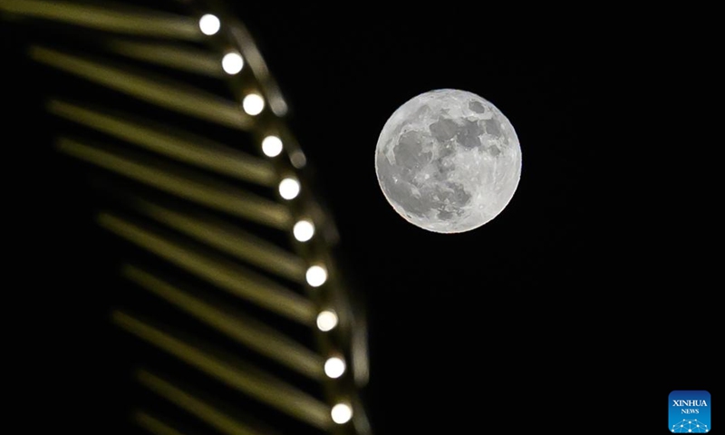 The full moon, known as the Blue Moon, rises over the skyline of Doha Corniche in Doha, Qatar, May 31, 2026. (Photo: Xinhua)