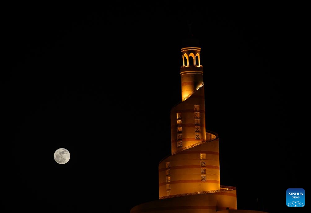 The full moon, known as the Blue Moon, is seen over the spiral minaret of the mosque of the Abdullah Bin Zaid Al Mahmoud Islamic Cultural Center in Doha, Qatar, May 31, 2026. (Photo: Xinhua)