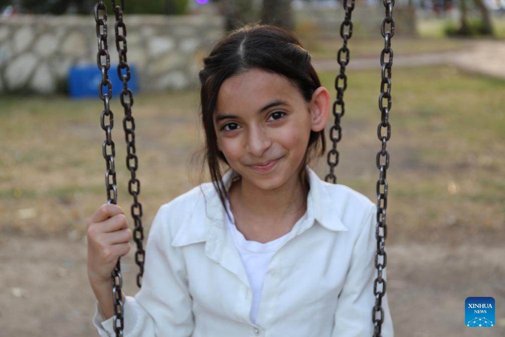 A girl plays on a swing at a park in Baghdad, Iraq, on May 31, 2026. June 1 is International Children's Day. (Photo: Xinhua)