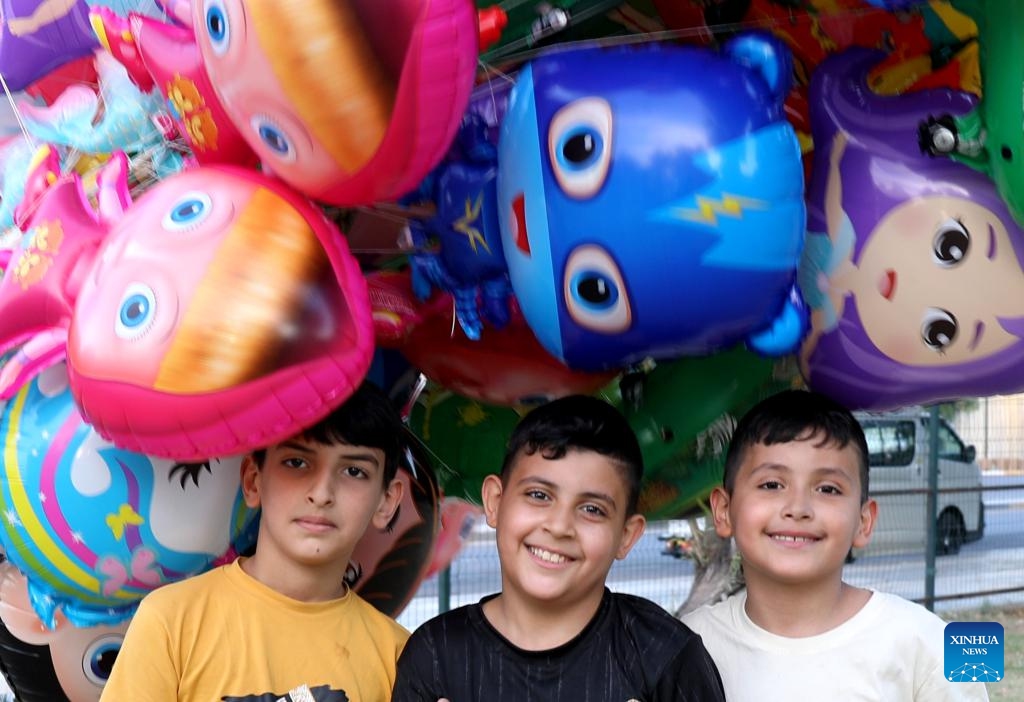 Boys pose for photos with balloons at a park in Baghdad, Iraq, May 31, 2026. June 1 is International Children's Day. (Photo: Xinhua)
