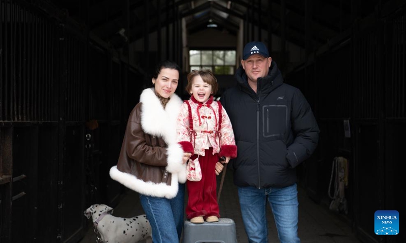 Maya and her parents pose for photos at the Yangtze River Delta International Equestrian Center in Dongting Town of Guangde City, east China's Anhui Province, Jan. 29, 2026. Four-year-old Maya Ivanou moved to China with her parents in 2023. The family settled in Dongting Town, home to the Yangtze River Delta International Equestrian Center. Maya's mother, Aleksandra Timofeeva, better known as Sasha, is an equestrian from Russia and her father, Vasil Ivanou, a coach from Belarus. (Photo: Xinhua)
