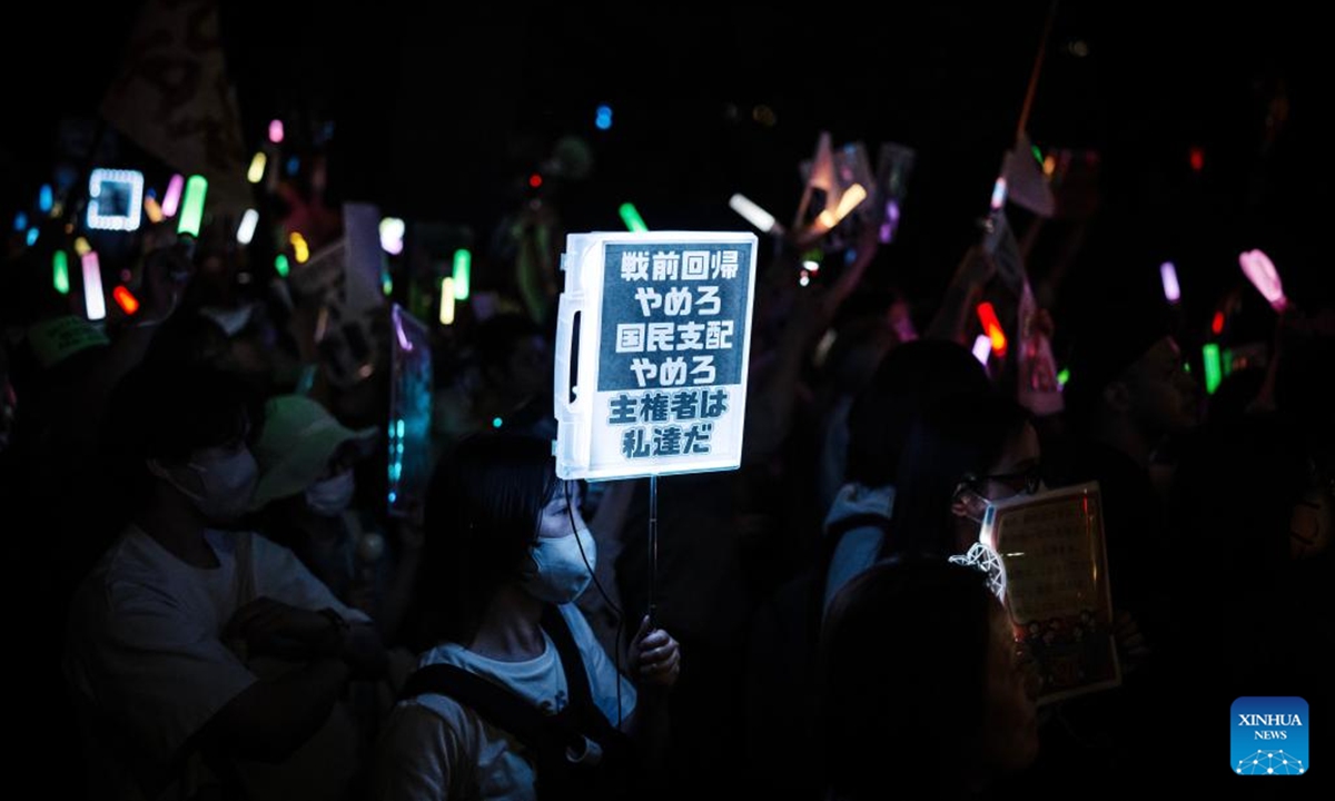 A woman holding a sign attends a protest rally in front of the National Diet Building in Tokyo, Japan, May 29, 2026. Around 10,000 people gathered in front of Japan's National Diet Building in Tokyo on Friday evening for an anti-war rally, protesting what they described as a series of dangerous policy moves pursued by the government of Prime Minister Sanae Takaichi. (Xinhua/Jia Haocheng)