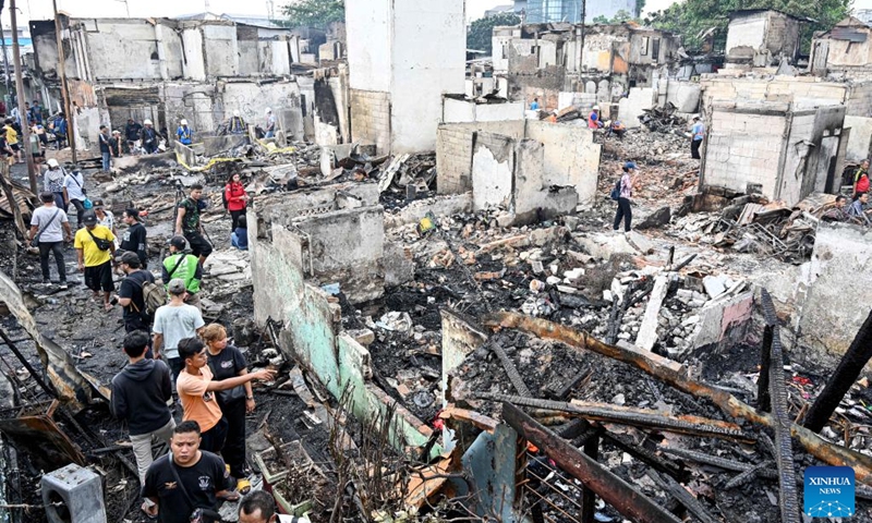 People check the damaged buildings after a fire hit a densely populated residential area in Kemayoran, Central Jakarta, Indonesia, on June 2, 2026. A massive fire, which swept through a densely populated residential area in Kemayoran, Central Jakarta, Monday night, has left three residents injured and forced hundreds of families to leave their homes, authorities said on Tuesday. (Photo: Xinhua)