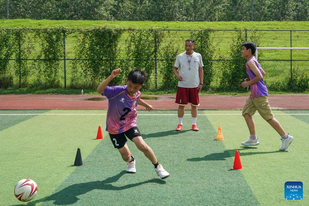 Children attend a football training session at Huikou Central Primary School in Susong County of Anqing, east China's Anhui Province, May 26, 2026. (Photo: Xinhua)