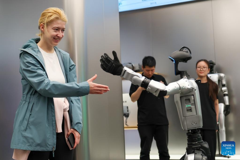 A Russian tourist interacts with a robot at a store of Unitree Robotics in Beijing, capital of China, April 30, 2026. Beijing received a total of 2.667 million inbound tourists in the first five months of this year, up 35.3 percent year-on-year, demonstrating the rising popularity of China Travel. As of May 11, the number of exits and entries by foreign nationals at Beijing ports had surpassed 2.55 million, accounting for 32 percent of the total inbound and outbound passenger volume and registering a year-on-year growth of 33.6 percent. (Photo: Xinhua)