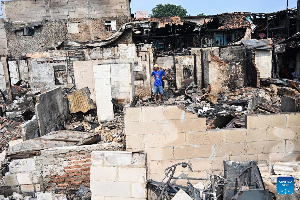 A man checks the damaged buildings after a fire hit a densely populated residential area in Kemayoran, Central Jakarta, Indonesia, on June 2, 2026. A massive fire, which swept through a densely populated residential area in Kemayoran, Central Jakarta, Monday night, has left three residents injured and forced hundreds of families to leave their homes, authorities said on Tuesday. (Photo: Xinhua)