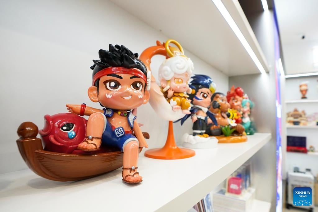 This photo taken on June 2, 2026 shows cultural and creative products inspired by the Hezhe culture at a creative industrial park in Tongjiang City, northeast China's Heilongjiang Province. Tongjiang City, home to one of the largest Hezhe communities in China, has stepped up efforts in recent years to safeguard intangible cultural heritage of Hezhe people, including Hezhen Yimakan storytelling, fish-skin craftsmanship, and local fishing and hunting customs. Such efforts aim to help the traditional ethnic culture thrive in modern times. (Photo: Xinhua)