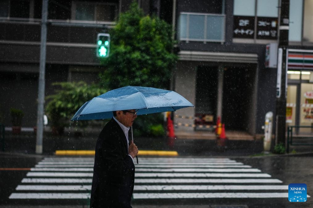 A man holding an umbrella walks on a street in rain brought by Typhoon Jangmi in Tokyo, Japan, June 3, 2026. (Photo: Xinhua)
