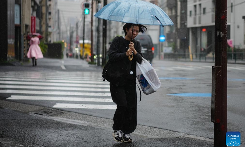 A woman holding an umbrella walks on a street in rain brought by Typhoon Jangmi in Tokyo, Japan, June 3, 2026. (Photo: Xinhua)
