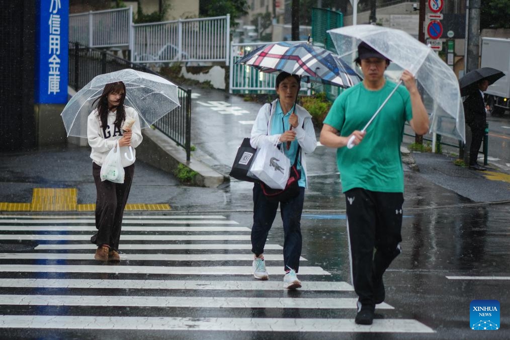 People holding umbrellas walk on a street in rain brought by Typhoon Jangmi in Tokyo, Japan, June 3, 2026. (Photo: Xinhua)