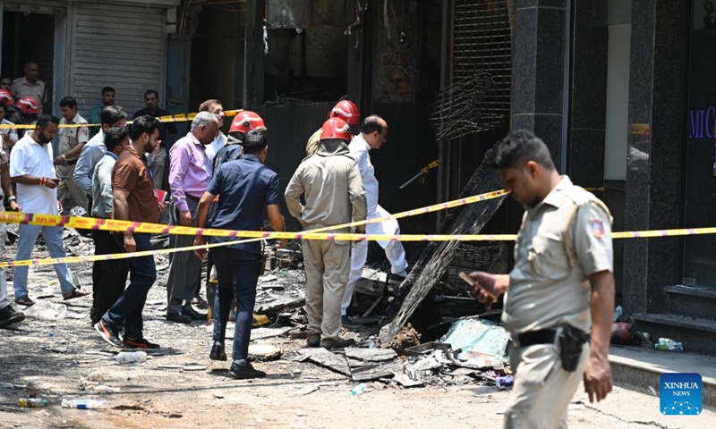 Indian policemen and officials inspect the site of a hotel fire in New Delhi, India, June 3, 2026. Up to 21 people were killed in a hotel fire here on Wednesday, local media reported. Over 35 people were rescued and later admitted to three different hospitals, a fire department official said. (Photo: Xinhua)