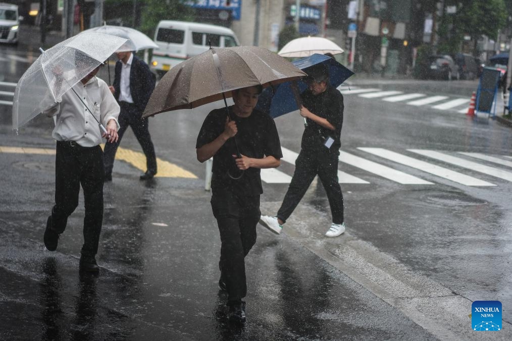 People holding umbrellas walk on a street in rain brought by Typhoon Jangmi in Tokyo, Japan, June 3, 2026. (Photo: Xinhua)