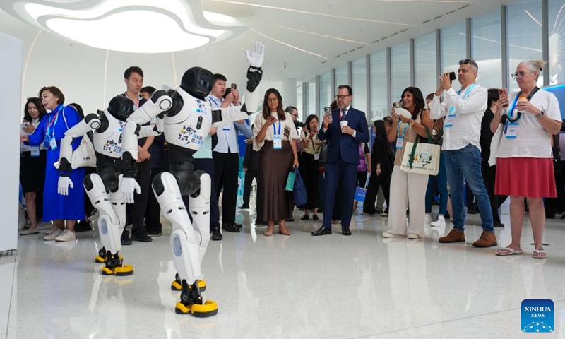 Guests watch robots dancing at Zhongguancun International Innovation Center on the sidelines of The 2026 Global Mayors Dialogue in Beijing, capital of China, June 2, 2026. The 2026 Global Mayors Dialogue - Beijing opened here on Tuesday, during which representatives from 56 countries and regions, and 73 cities discussed on the digital and intelligent development of city tourism and a better city life prospect brought by the transformation and upgrading of tourism. (Photo: Xinhua)