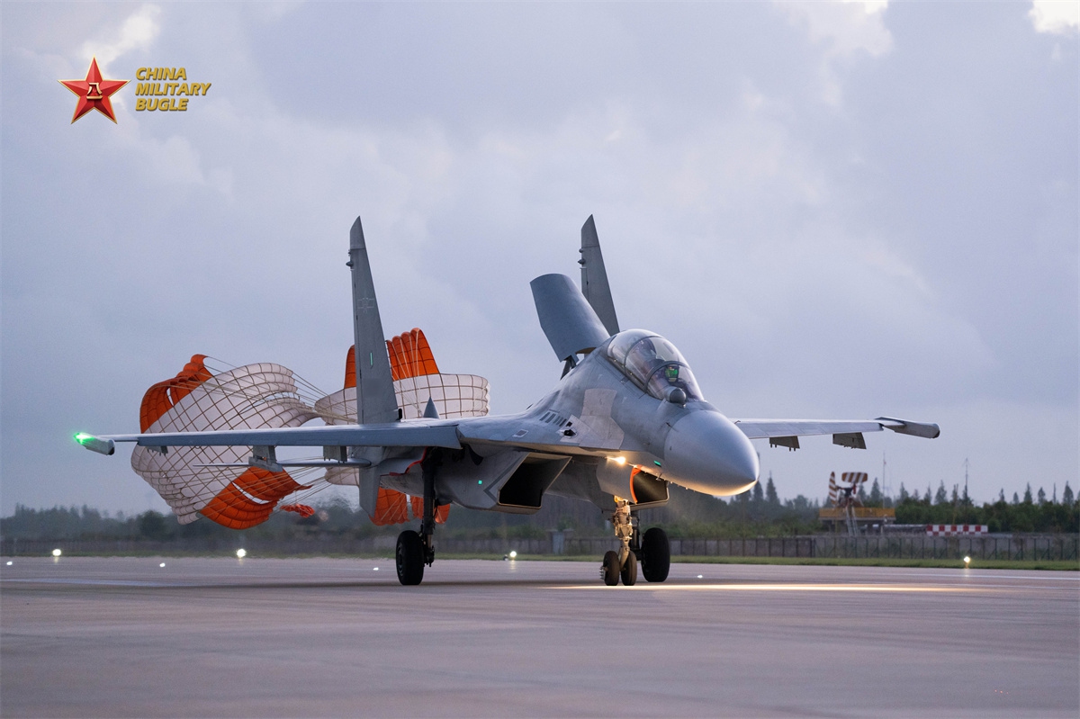 A J-16 fighter jet attached to an aviation troop with the air force under the Chinese PLA Eastern Theater Command deploys its drag-chute to slow down on the runway during a recent multi-sortie flight training exercise. (eng.chinamil.com.cn/Photo by Xing Zhitao)