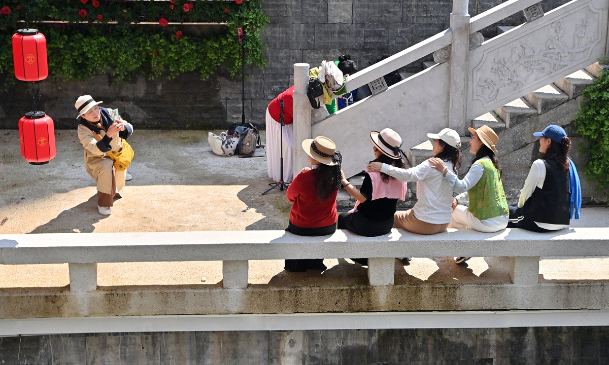 Citizens pose for photos at the revitalized Guancheng River's Nanming Section in Guiyang,on April 30, 2026. Photo: VCG