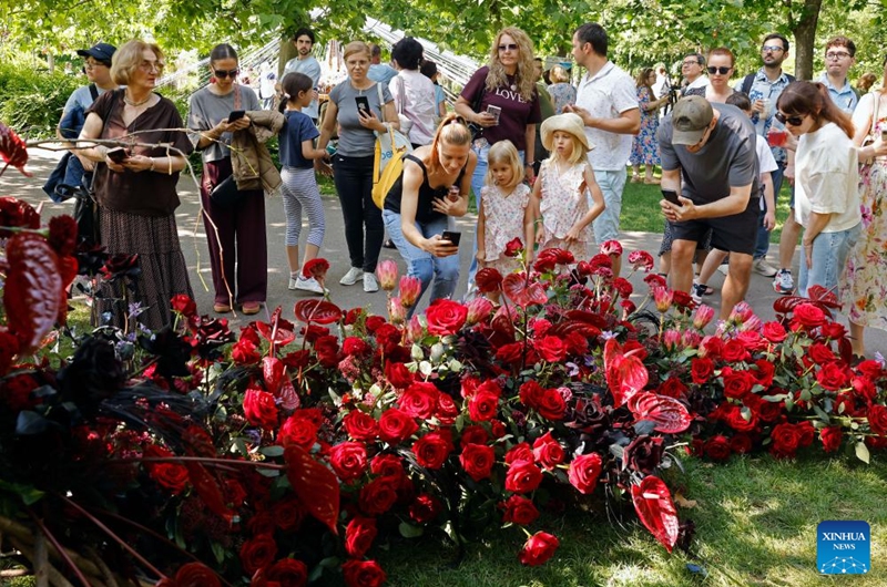 Visitors take pictures during the opening day of the 4th edition of West Side Flower Fest in Bucharest, Romania, on June 5, 2026. (Photo by Cristian Cristel/Xinhua)