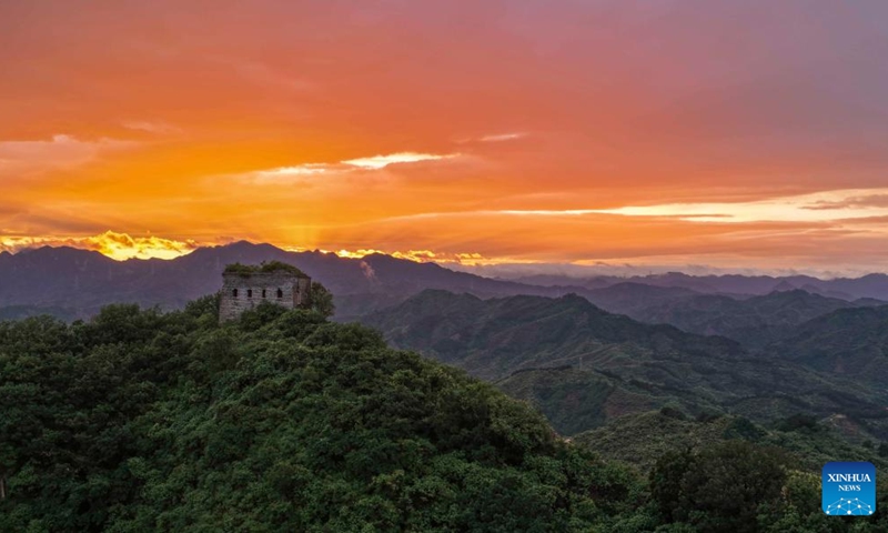 An aerial drone photo taken on June 6, 2026 shows the scenery of the Great Wall at sunset in Zunhua City of north China's Hebei Province. (Photo by Liu Mancang/Xinhua)