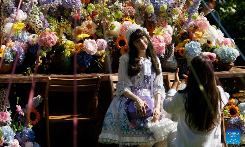 A woman poses for pictures during the opening day of the 4th edition of West Side Flower Fest in Bucharest, Romania, on June 5, 2026. (Photo by Cristian Cristel/Xinhua)