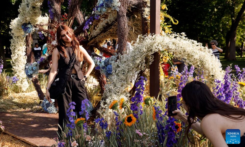 A woman poses for pictures during the opening day of the 4th edition of West Side Flower Fest in Bucharest, Romania, on June 5, 2026. (Photo by Cristian Cristel/Xinhua)