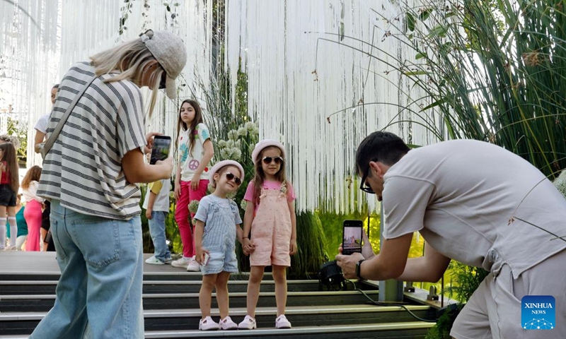 Visitors take pictures during the opening day of the 4th edition of West Side Flower Fest in Bucharest, Romania, on June 5, 2026. (Photo by Cristian Cristel/Xinhua)