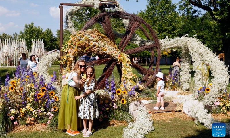 Visitors take pictures during the opening day of the 4th edition of West Side Flower Fest in Bucharest, Romania, on June 5, 2026. (Photo by Cristian Cristel/Xinhua)