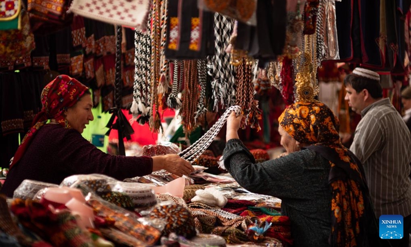 A customer selects products at the Oriental Bazaar in Ashgabat, Turkmenistan, June 7, 2026. (Photo by Cui Jiaxin/Xinhua)