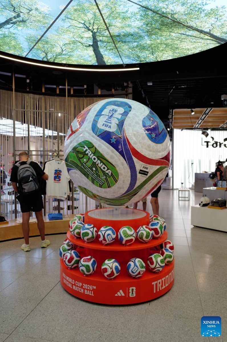 A man checks out merchandise at an official FIFA World Cup 2026 store in Toronto, Canada, on June 7, 2026. (Photo by Yang Shu/Xinhua)