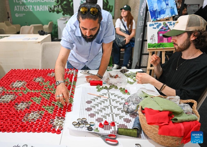 People make handicrafts using recycled bottle caps at the Zero Waste Festival in Istanbul, Türkiye, on June 6, 2026. The Zero Waste Festival is being held in Istanbul from June 4 to 7. (Xinhua/Liu Lei)