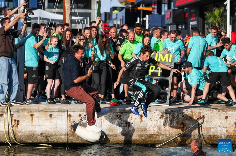 Mercedes' Kimi Antonelli (front R) jumps to the Mediterranean Sea for celebrating his win after the Formula One Monaco Grand Prix at Circuit de Monaco in Monte Carlo, Monaco, June 7, 2026. (Photo by Bao Di/Xinhua)
