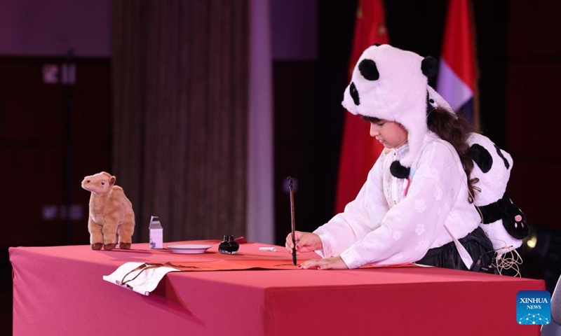 A competitor performs Chinese calligraphy during the final of the 2026 Chinese Bridge Language Proficiency Competition in Dubai, the United Arab Emirates (UAE), June 6, 2026. Photo: Xinhua