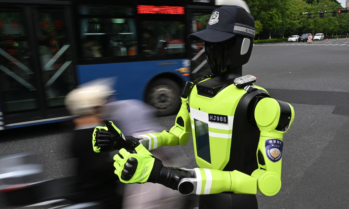 An AI-powered traffic management humanoid robot stations near a college entrance examinations site in Hangzhou, East China's Zhejiang Province on June 8, 2026. Equipped with computer vision technology, the robot identifies passing vehicles and reminds drivers not to honk during examinations. Photo: VCG