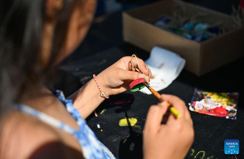 A child takes part in a workshop making handicrafts from recycled bottle caps at the Zero Waste Festival in Istanbul, Türkiye, on June 6, 2026. The Zero Waste Festival is being held in Istanbul from June 4 to 7. (Xinhua/Liu Lei)