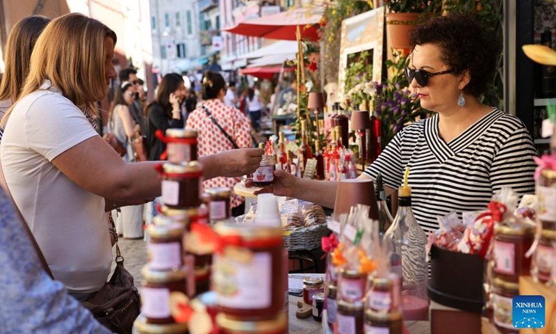 A tourist tastes strawberry jam at 2026 Nemi Strawberry Festival in Nemi, Lazio, Italy, June 7, 2026. (Xinhua/Li Jing)