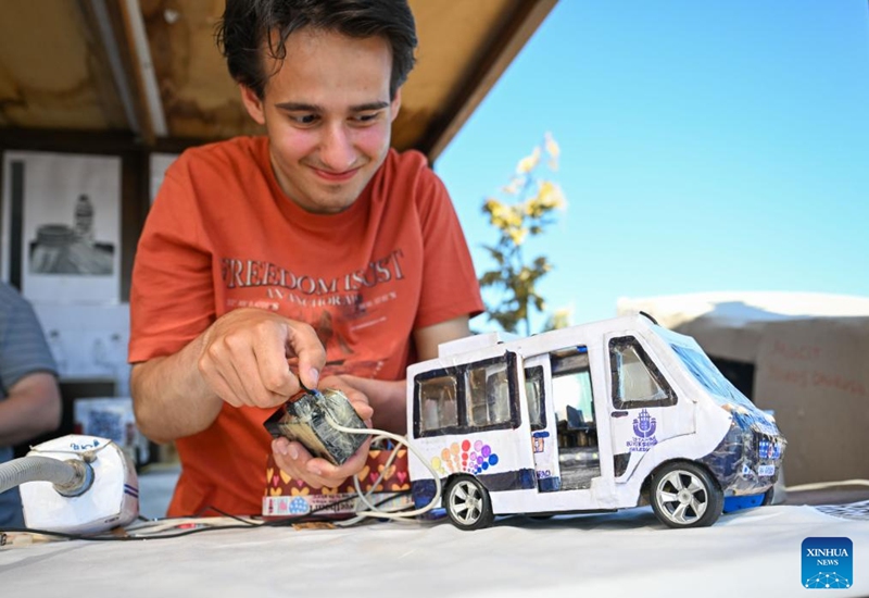 A man presents an electric bus model made from waste materials at the Zero Waste Festival in Istanbul, Türkiye, on June 6, 2026. The Zero Waste Festival is being held in Istanbul from June 4 to 7. (Xinhua/Liu Lei)