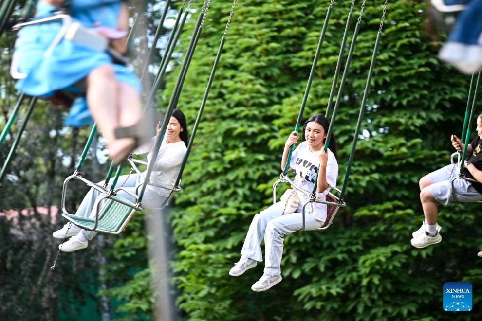 People enjoy an amusement facility at Central Park in Almaty, Kazakhstan, on June 8, 2026. (Photo: Xinhua)