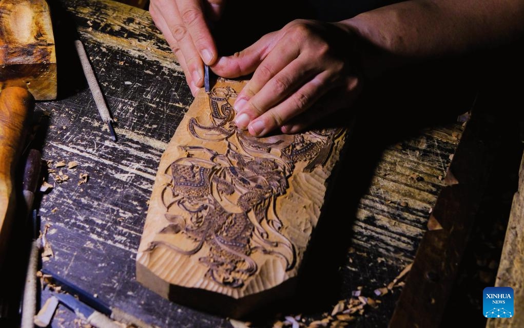 Xu Xiaoyi, a municipal-level inheritor of the Wuqiang woodblock New Year painting technique, works on a woodblock painting at the Wuqiang woodblock New Year painting museum in Wuqiang County of Hengshui, north China's Hebei Province, June 6, 2026. In recent years, efforts have been made to pass on and promote the intangible cultural heritages endemic to Hengshui. Meanwhile, derivative cultural and creative products continue to reach overseas markets, which act as a carrier of the cultural appeal of Hengshui. (Photo: Xinhua)