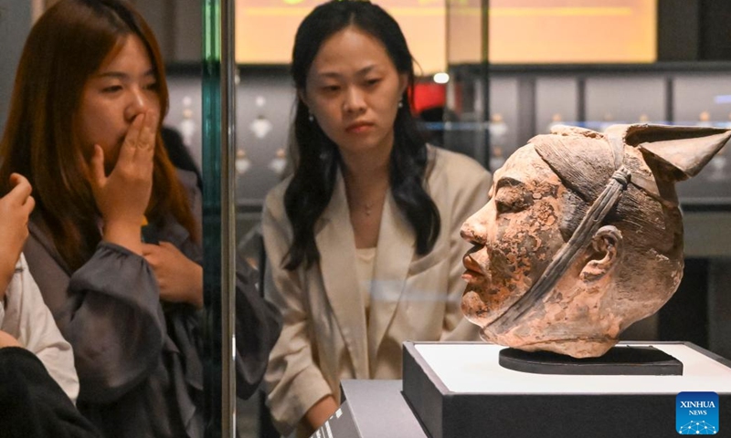 Media staff members view an exhibit during a press preview of the exhibition Dawn of The First Empire: The Qin's Unification in Archaeological Treasures at the Shanghai Museum in Shanghai, east China, June 9, 2026. The exhibition will be open to the public from June 10 to Sept. 7, displaying 328 sets (510 pieces) of cultural relics from 14 archaeological and cultural heritage institutions from northwest China's Gansu and Shaanxi provinces and Shanghai. (Photo: Xinhua)
