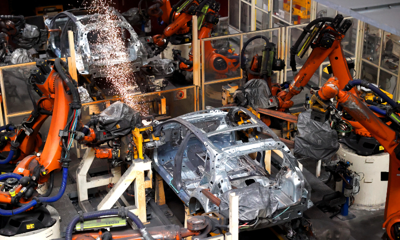 A group of robotic arms perform welding at a FAW-Volkswagen workshop in Jimo district, Qingdao city, East China's Shandong Province, on June 17, 2026. As a pillar industry in Jimo, the automotive sector there has shifted to turning out smart, green and high-end new-energy vehicles. The district is home to over 400 automotive enterprises, with an annual production capacity of 450,000 auto vehicles, driving local economic growth. Photo: VCG
