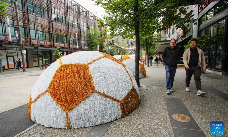 People walk past a soccer-themed public art installation in downtown Vancouver, British Columbia, Canada, June 9, 2026. Vancouver is making final preparations to welcome fans from around the world for the 2026 FIFA World Cup. (Photo: Xinhua)
